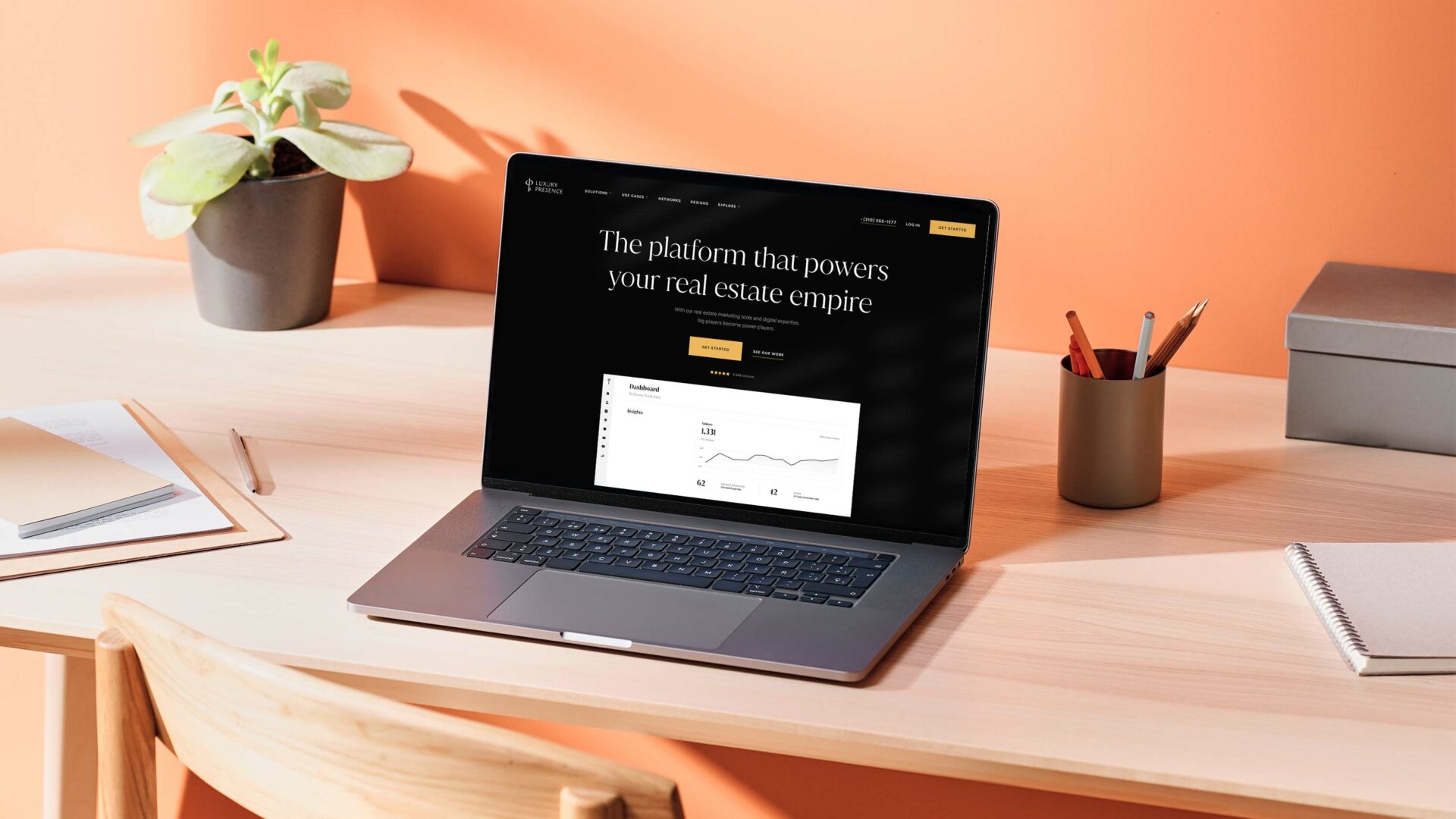 A laptop on a desk with a webpage open about "Building the Perfect Agent Website" with Luxury Presence.