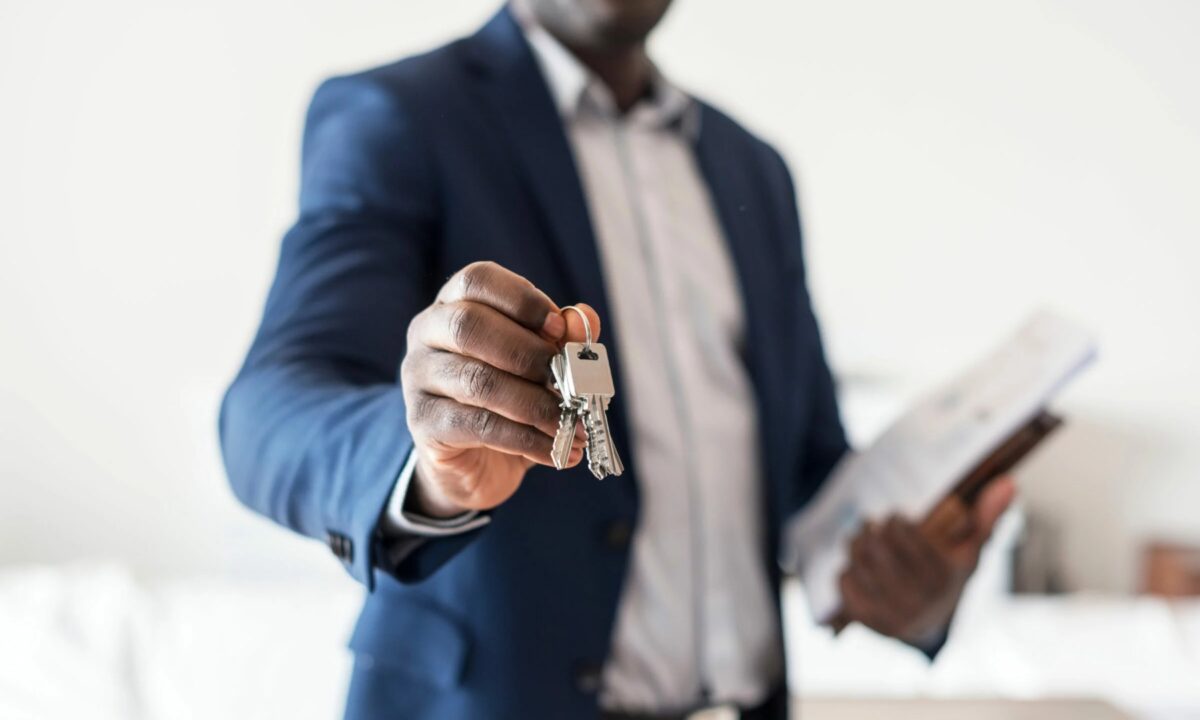 A real estate agent endorsing a key to a real estate property.