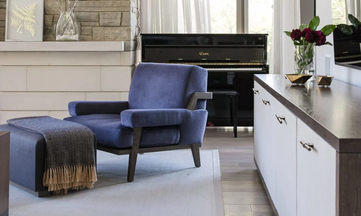 Image of blue chair sitting in front of piano in living room